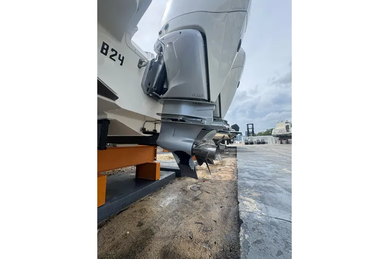 Slide: The Image of 2021 Boston Whaler 320 Vantage boat engines on display at a marina. - 16
