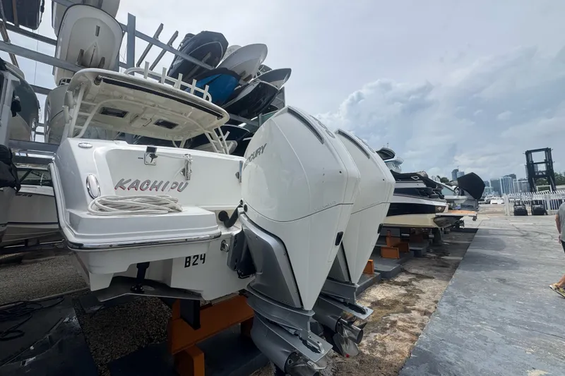 Slide: The Image of 2021 Boston Whaler 320 Vantage boat with dual Mercury engines on a dock. - 24