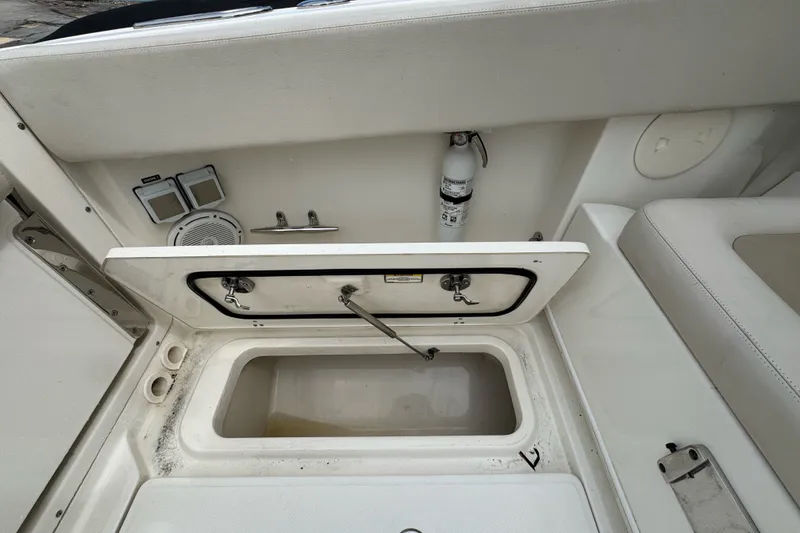 Slide: The Image of Storage compartment on a 2021 Boston Whaler 320 Vantage boat, featuring safety equipment. - 34