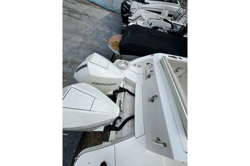 Slide: The Image of 2021 Boston Whaler 320 Vantage with dual Mercury outboard engines, docked at marina. - 26
