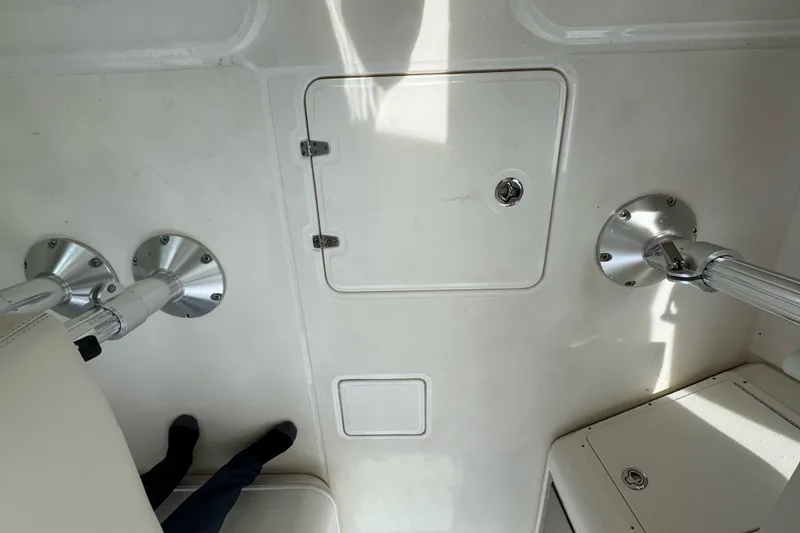 Slide: The Image of Interior view of a 2021 Boston Whaler 320 Vantage boat, featuring deck fittings and storage compartments. - 66