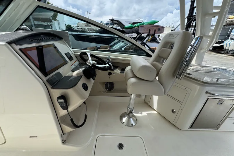 Slide: The Image of 2021 Boston Whaler 320 Vantage helm with modern controls and comfortable seating. - 63