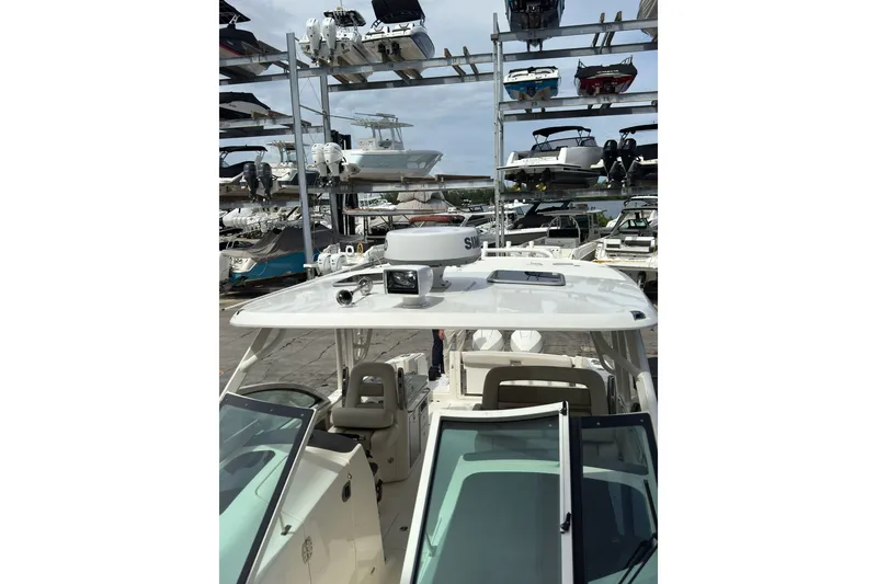 Slide: The Image of 2021 Boston Whaler 320 Vantage boat in storage, surrounded by other vessels. - 86