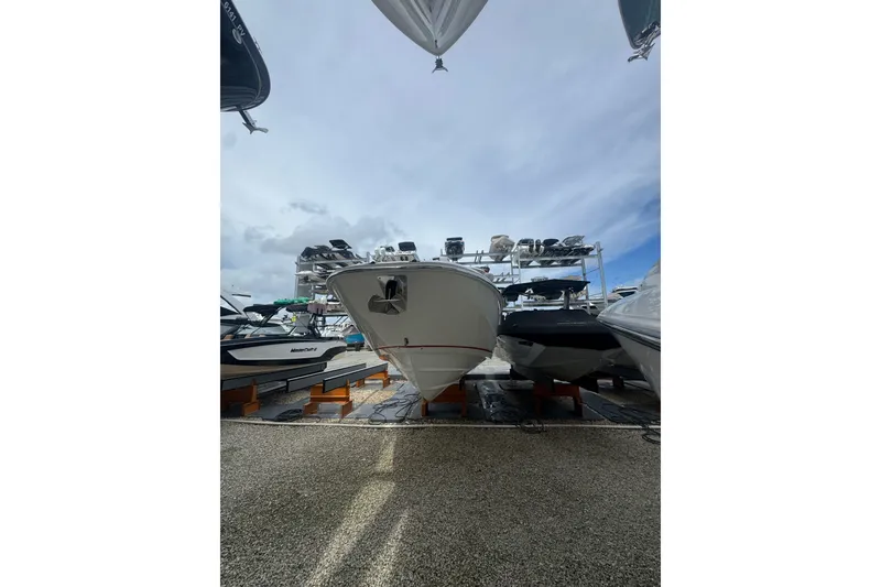 Slide: The Image of 2021 Boston Whaler 320 Vantage boat displayed in a marina under a cloudy sky. - 23