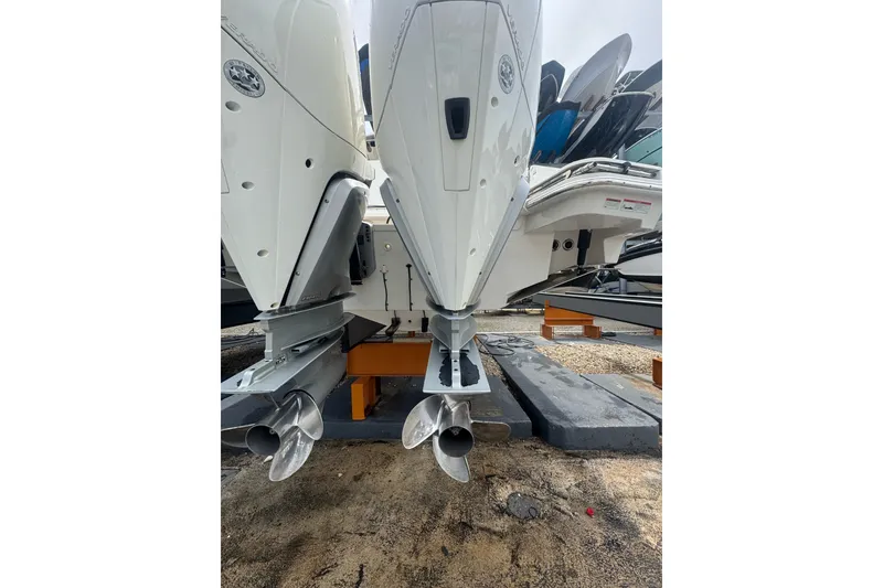 Slide: The Image of 2021 Boston Whaler 320 Vantage boat engines on display in a marina setting. - 20