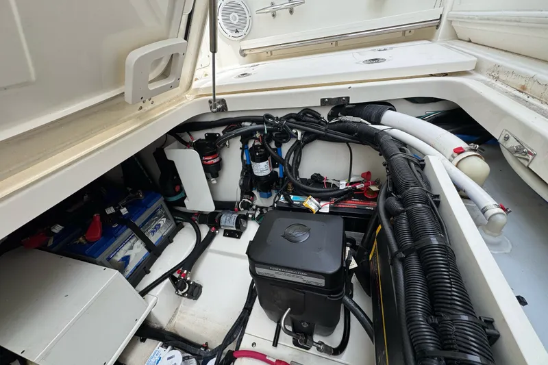 Slide: The Image of 2021 Boston Whaler 320 Vantage engine compartment with wiring and battery setup. - 38