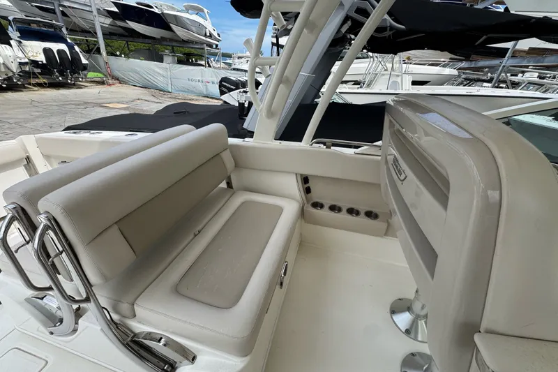 Slide: The Image of 2021 Boston Whaler 320 Vantage boat interior with seating and stainless steel fixtures. - 55