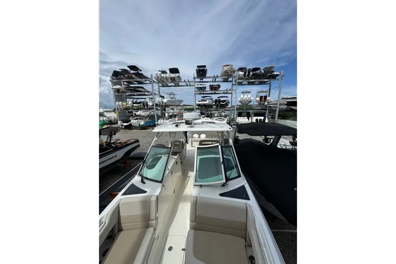 Slide: The Image of 2021 Boston Whaler 320 Vantage boat in marina storage, under a clear blue sky. - 85