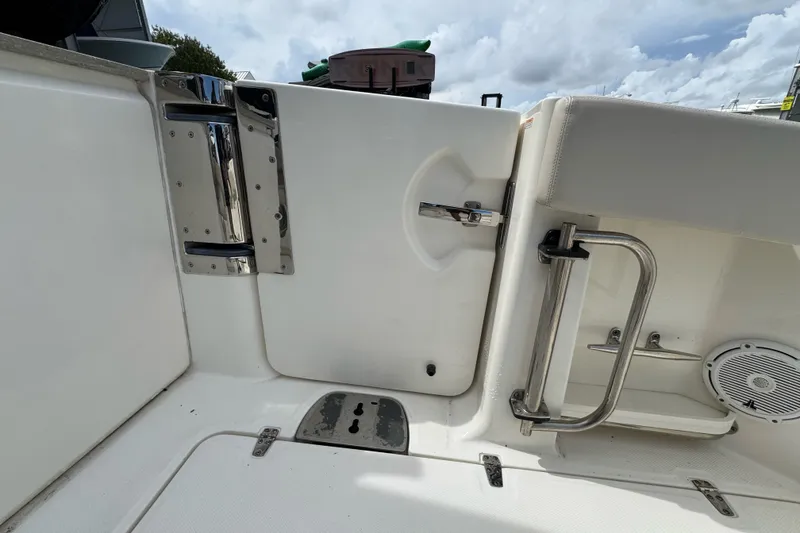 Slide: The Image of 2021 Boston Whaler 320 Vantage boat interior, featuring stainless steel fixtures and seating. - 42