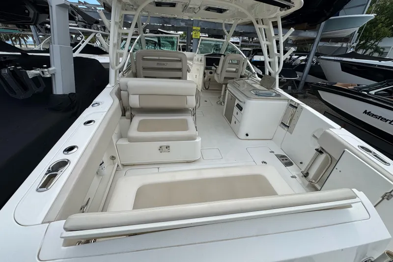 Slide: The Image of 2021 Boston Whaler 320 Vantage boat interior with seating and helm station. - 28