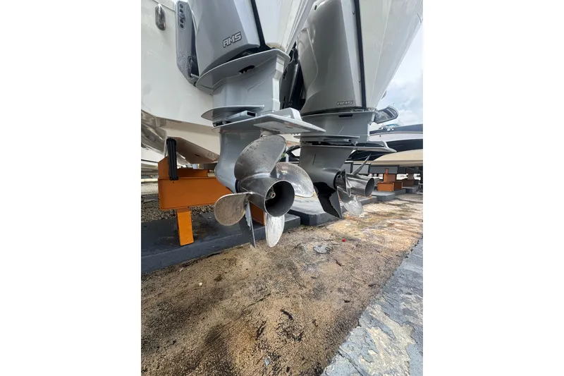 Slide: The Image of 2021 Boston Whaler 320 Vantage boat propellers on display, showcasing dual outboard engines. - 19