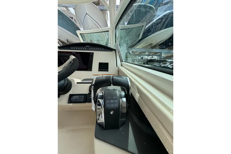 Slide: The Image of 2021 Boston Whaler 320 Vantage helm with steering wheel and control panel. - 60