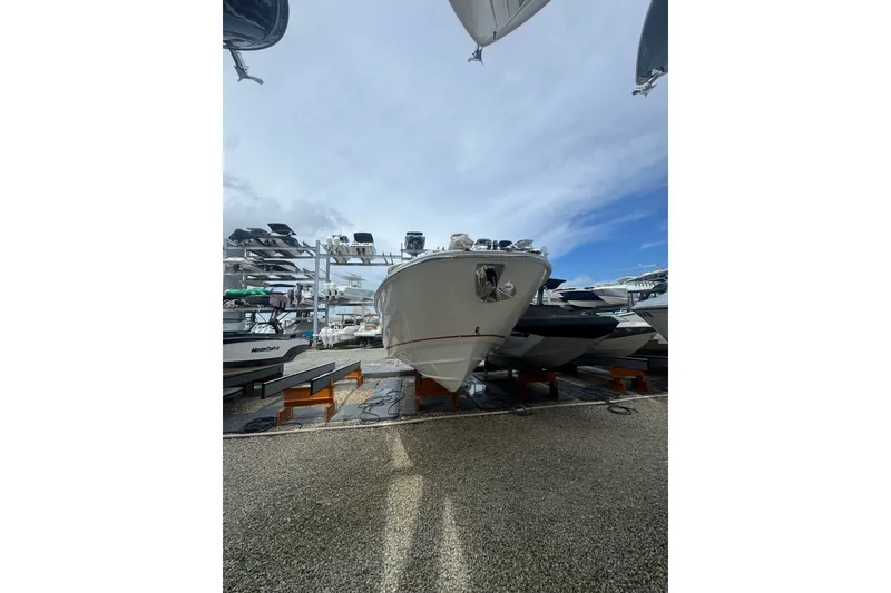 Slide: The Image of 2021 Boston Whaler 320 Vantage boat on display in a marina setting. - 22
