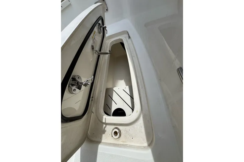 Slide: The Image of Open storage compartment on a 2021 Boston Whaler 320 Vantage boat. - 77
