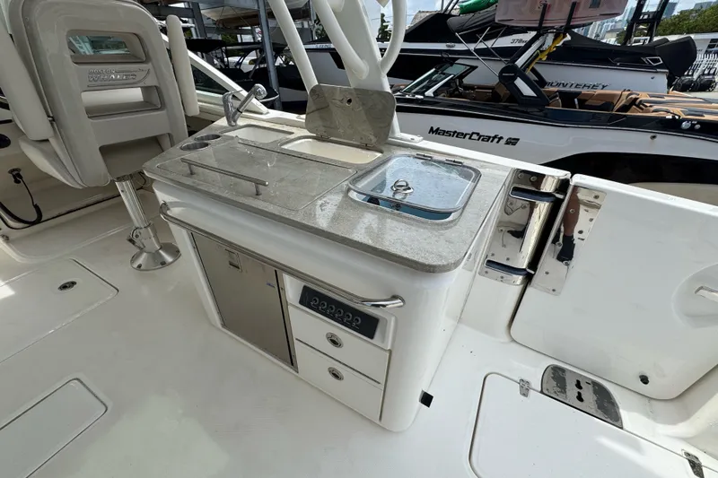Slide: The Image of Boston Whaler 320 Vantage 2021 boat interior with kitchenette and seating area. - 46