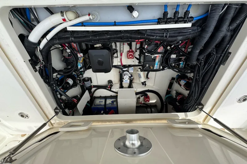 Slide: The Image of 2021 Boston Whaler 320 Vantage engine compartment with wiring and components. - 36