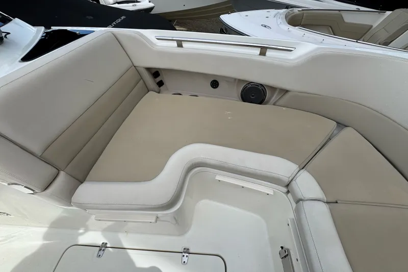 Slide: The Image of 2021 Boston Whaler 320 Vantage boat interior seating area with beige cushions. - 79
