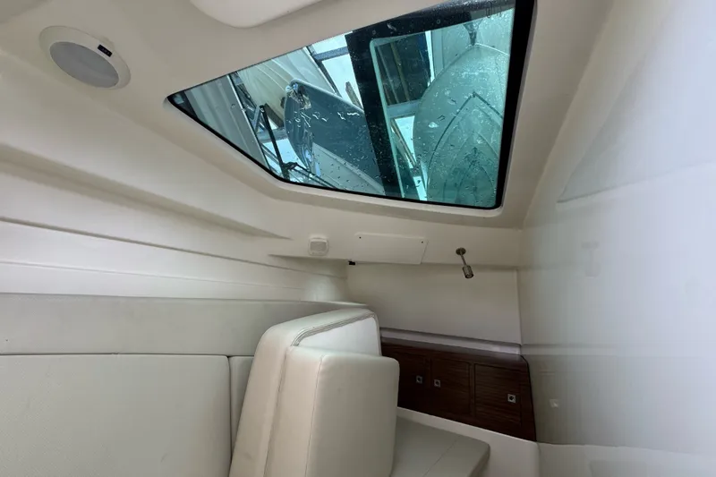 Slide: The Image of Interior cabin of 2021 Boston Whaler 320 Vantage with seating and window view. - 73
