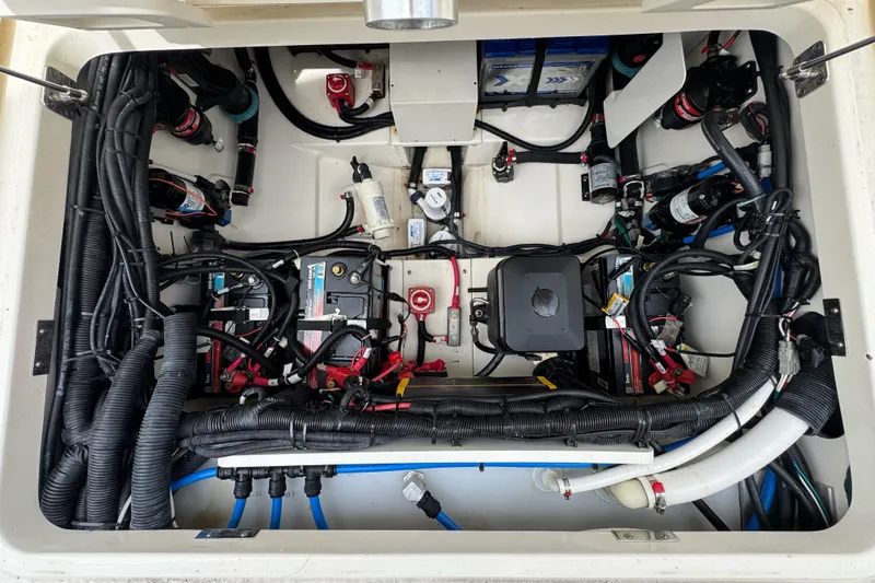 Slide: The Image of Engine compartment of a 2021 Boston Whaler 320 Vantage, showcasing wiring and components. - 39