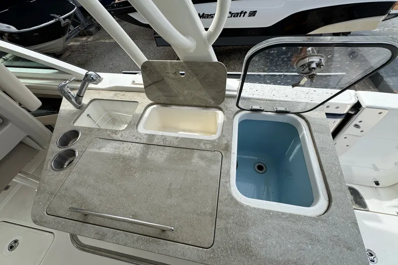 Slide: The Image of 2021 Boston Whaler 320 Vantage boat sink and countertop with storage compartments. - 48