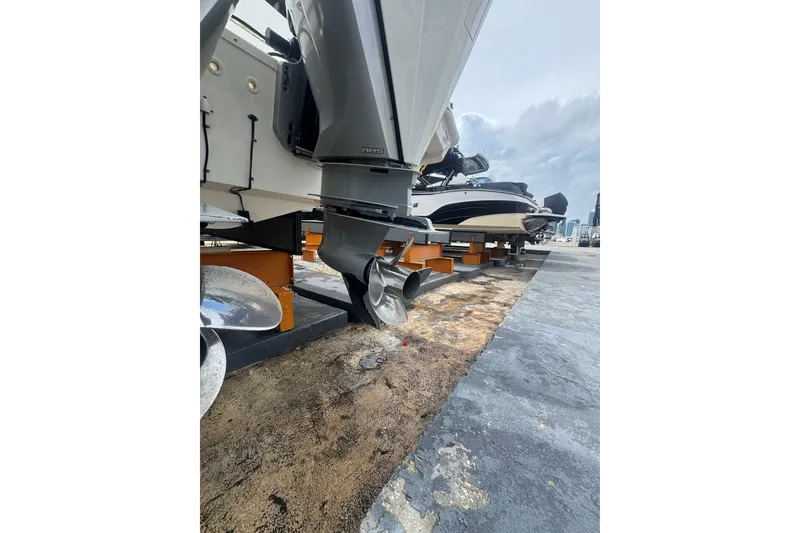 Slide: The Image of 2021 Boston Whaler 320 Vantage boat on dock, showcasing propeller and engine details. - 18