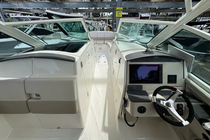 Slide: The Image of 2021 Boston Whaler 320 Vantage boat interior with steering wheel and control panel. - 75