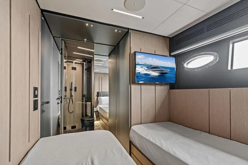 Slide: The Image of Luxurious interior of 2025 Pershing GTX 80 yacht with modern design and twin beds. - 86