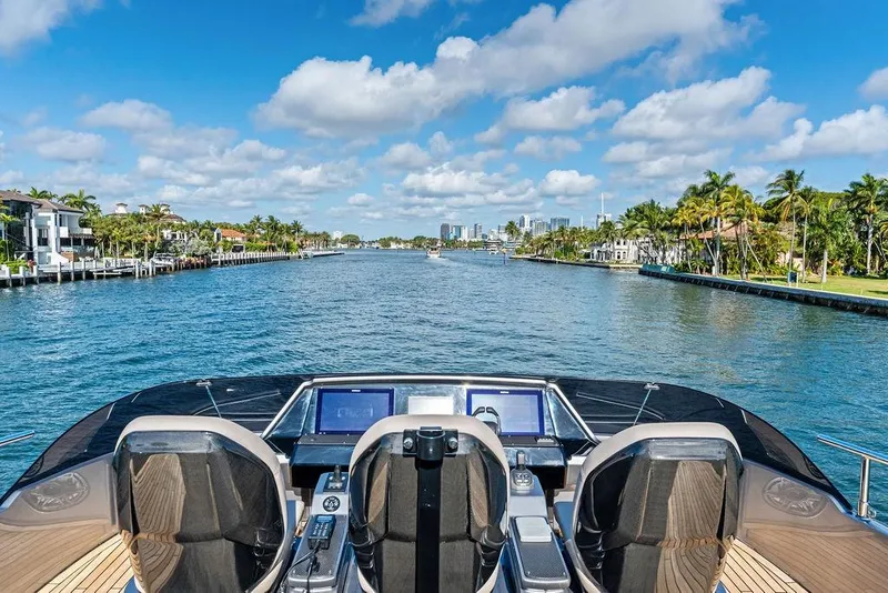 Slide: The Image of Luxury yacht Pershing GTX 80 cruising a scenic waterway, 2025 model, clear skies, palm-lined shores. - 29