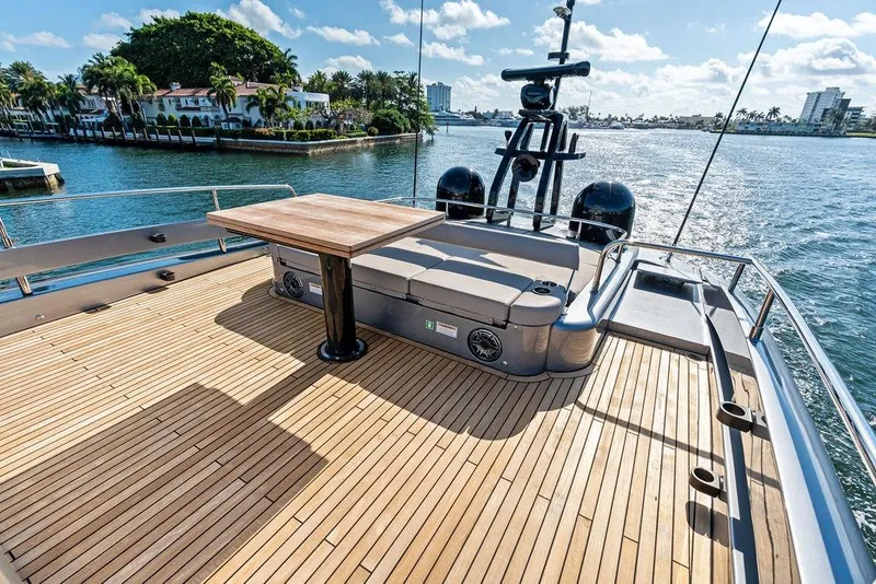 Slide: The Image of Luxurious 2025 Pershing GTX 80 yacht deck with wooden flooring and scenic waterfront view. - 31