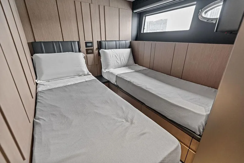 Slide: The Image of Interior cabin of 2025 Pershing GTX 80 yacht with twin beds and modern design. - 84