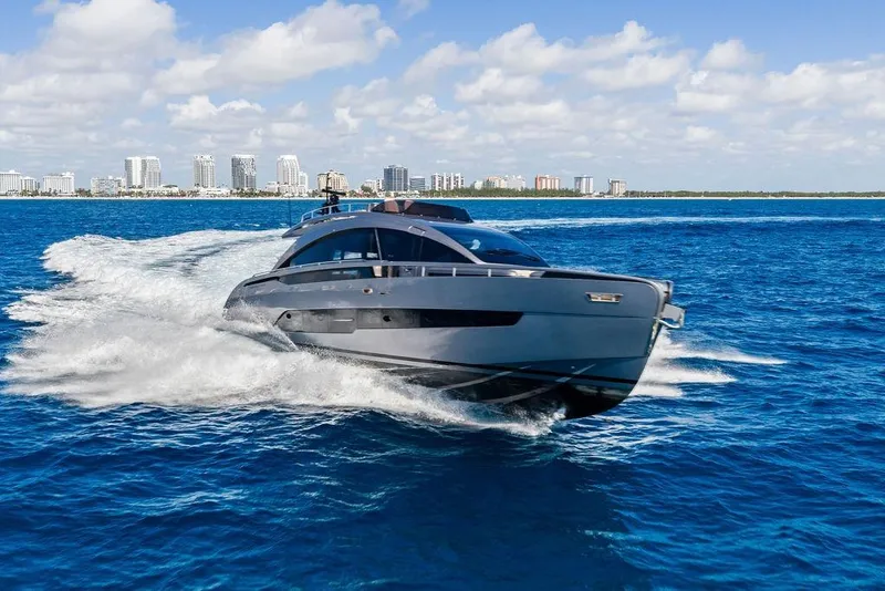 Slide: The Image of 2025 Pershing GTX 80 yacht cruising on blue ocean near city skyline. - 25