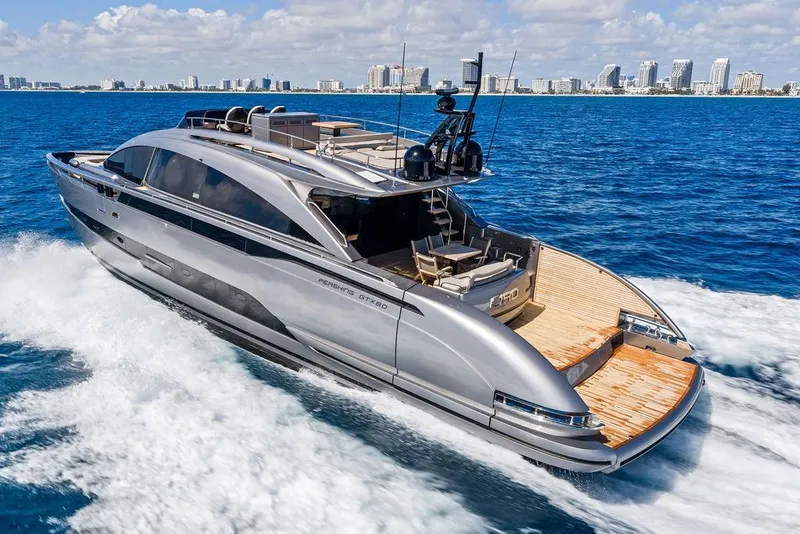 Slide: The Image of Luxury Pershing GTX 80 yacht cruising on blue ocean, city skyline in background, 2025 model. - 22