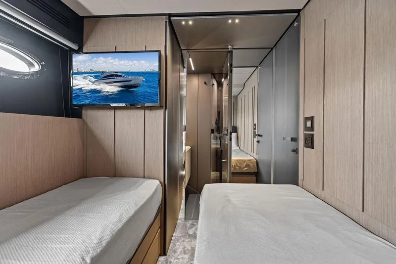 Slide: The Image of Luxurious interior of 2025 Pershing GTX 80 yacht with twin beds and modern decor. - 85