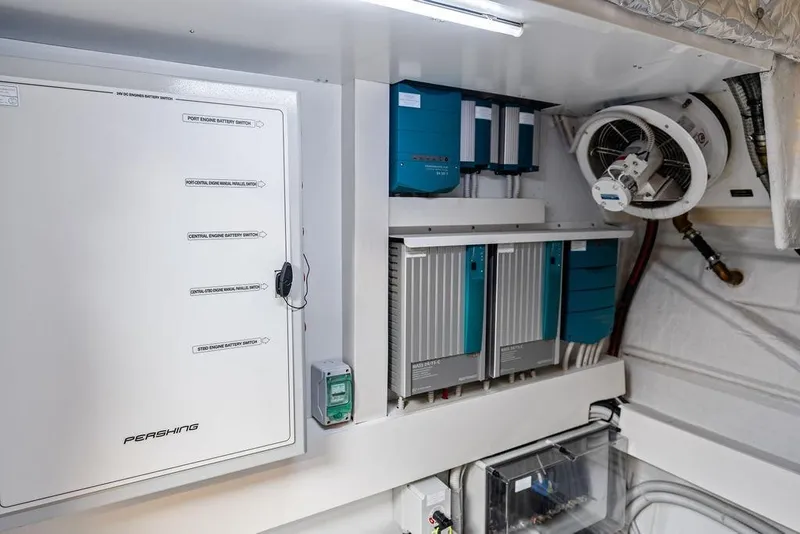 Slide: The Image of Engine room of 2025 Pershing GTX 80 yacht with battery switches and electrical systems. - 94