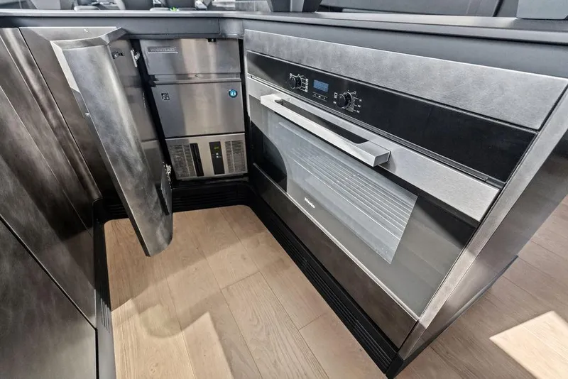 Slide: The Image of Modern kitchen appliances in Pershing GTX 80 yacht, 2025 model, featuring sleek metallic finishes. - 68