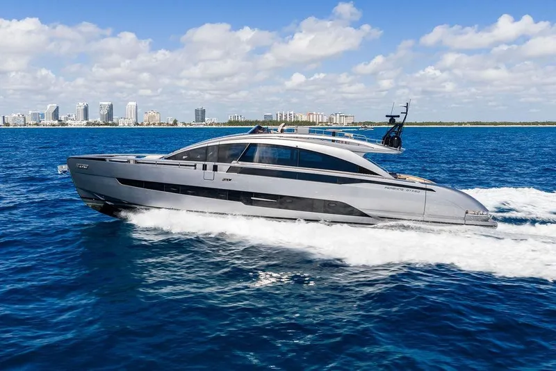 Slide: The Image of 2025 Pershing GTX 80 yacht cruising on blue ocean near city skyline. - 23
