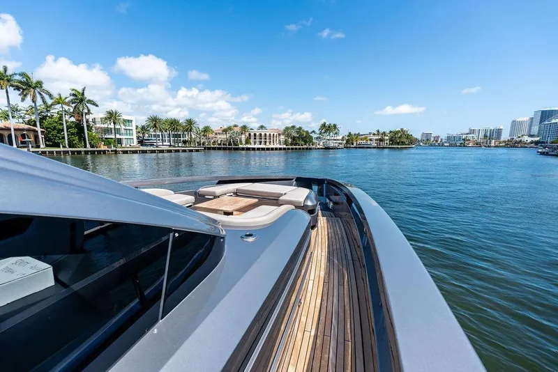 Slide: The Image of 2025 Pershing GTX 80 yacht cruising on a sunny waterfront with palm trees. - 45