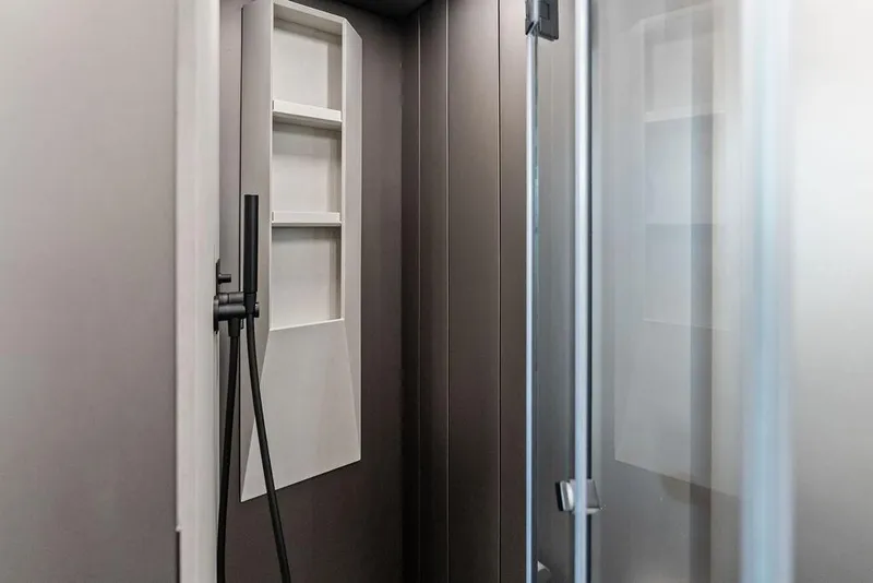 Slide: The Image of Modern shower interior in 2025 Pershing GTX 80 yacht, featuring sleek design and shelving. - 89