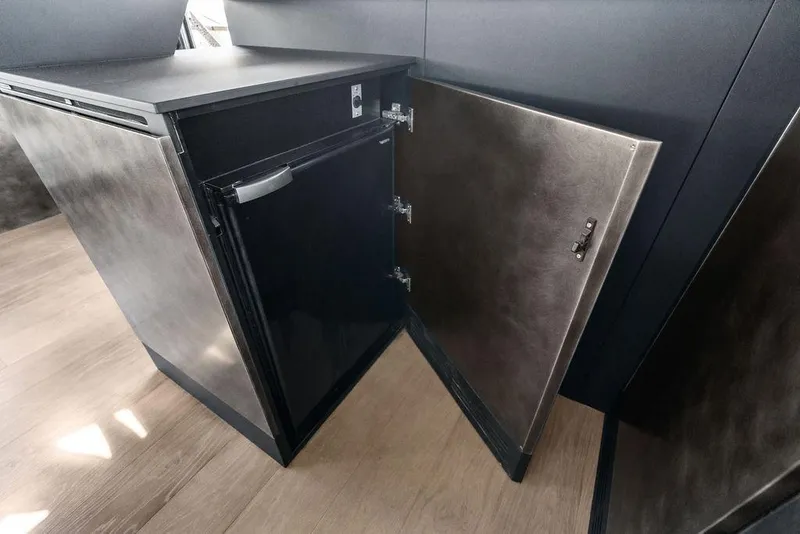 Slide: The Image of Modern interior of Pershing GTX 80 yacht, featuring sleek cabinetry and compact refrigerator, 2025 model. - 69