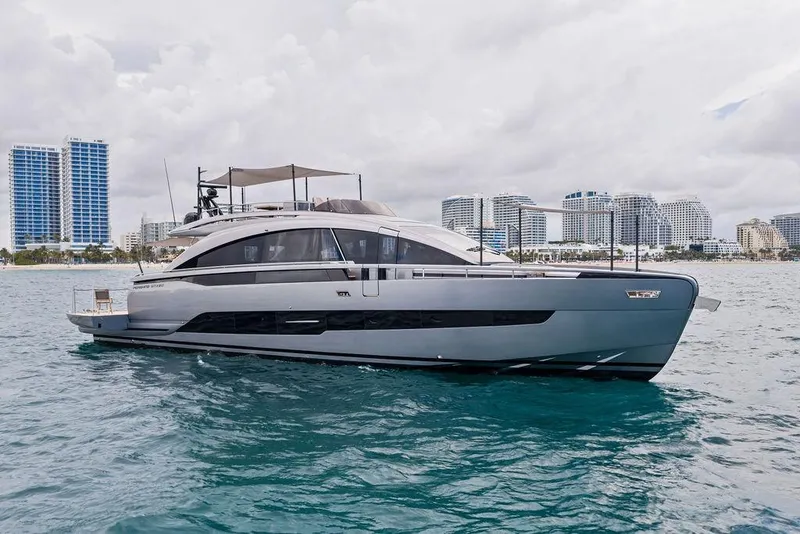 Slide: The Image of Luxury Pershing GTX 80 yacht cruising near modern city skyline, 2025 model. - 2