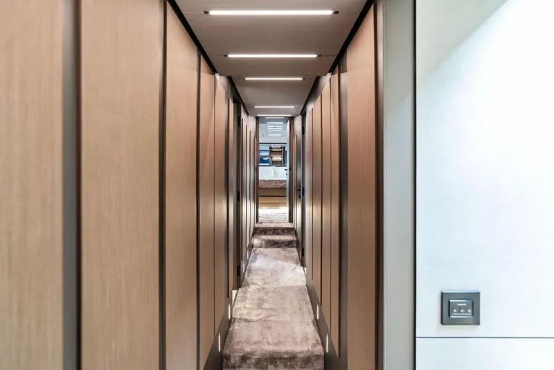 Slide: The Image of Luxurious hallway interior of 2025 Pershing GTX 80 yacht with modern lighting. - 71