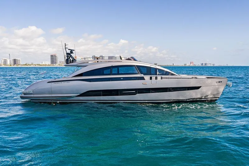 Slide: The Image of 2025 Pershing GTX 80 yacht cruising on clear blue ocean near city skyline. - 16