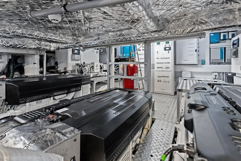 Slide: The Image of Engine room of 2025 Pershing GTX 80 yacht, featuring advanced machinery and control panels. - 98