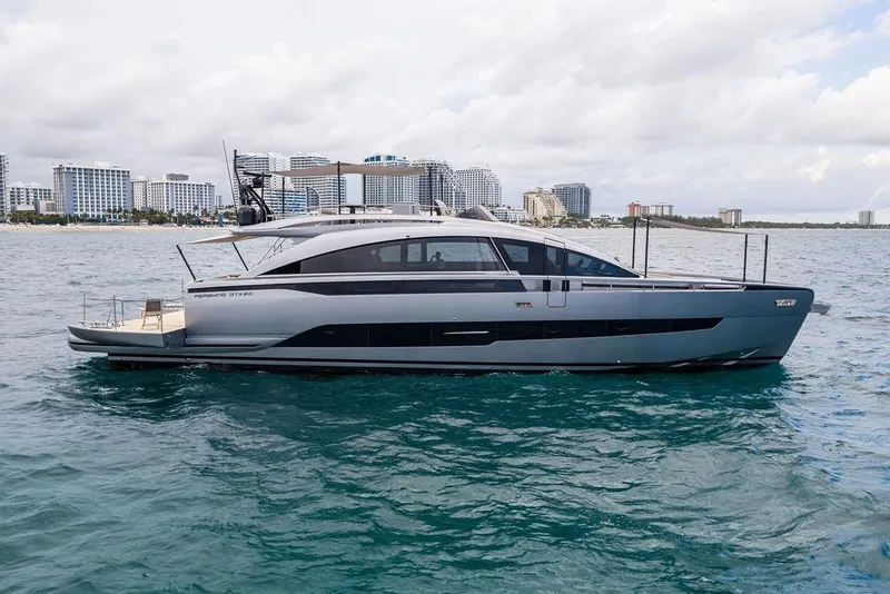 Slide: The Image of 2025 Pershing GTX 80 yacht cruising near a city skyline on a sunny day. - 11