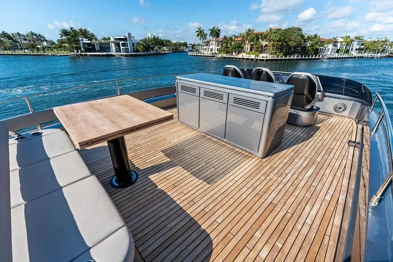 Slide: The Image of Luxurious 2025 Pershing GTX 80 yacht deck with seating, table, and scenic waterfront view. - 28