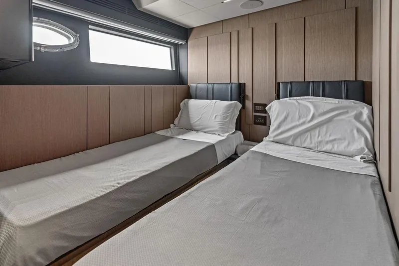 Slide: The Image of Luxurious twin cabin interior on 2025 Pershing GTX 80 yacht, featuring sleek modern design. - 81