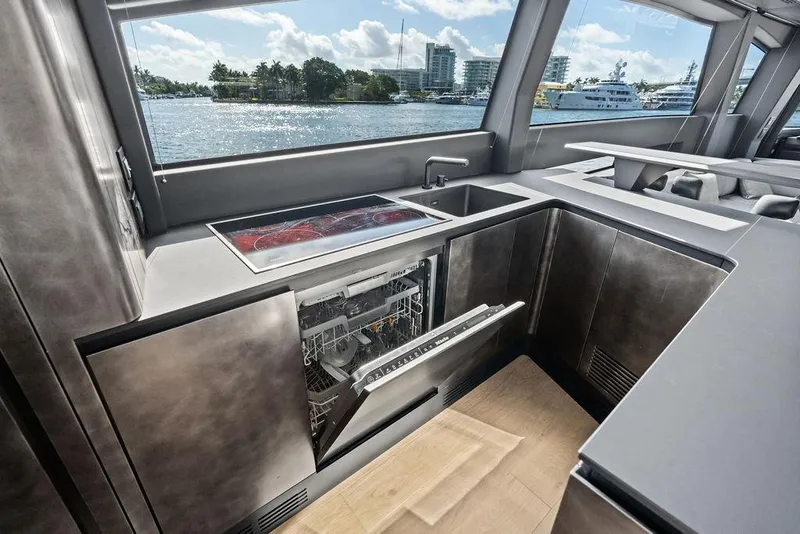 Slide: The Image of Modern kitchen interior on 2025 Pershing GTX 80 yacht with dishwasher and scenic window view. - 67