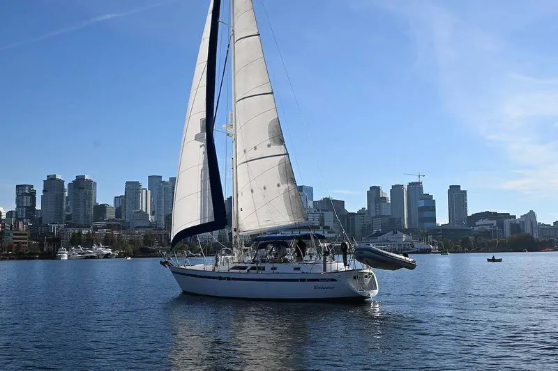 Slide: The Image of Sailboat "Taswell 43" by Ta Shing Yachts (1989) on water with city skyline backdrop. - 2