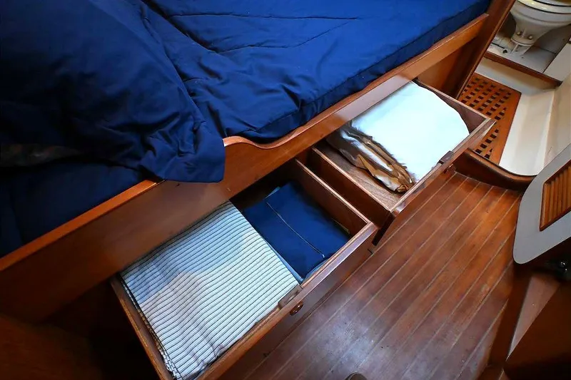 Slide: The Image of Cozy cabin interior of 1989 Ta Shing Taswell 43 yacht with wooden drawers and blue bedding. - 63