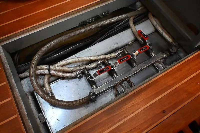 Slide: The Image of Engine compartment of 1989 Ta Shing Yachts Taswell 43, showcasing hoses and valves. - 79